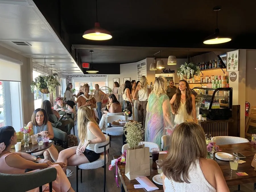 ICONS members mingling together inside a cafe during a Coffee & Connections event