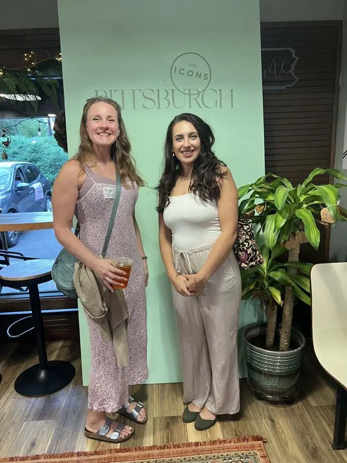 Two members at the ICONS of Pittsburgh step-and-repeat