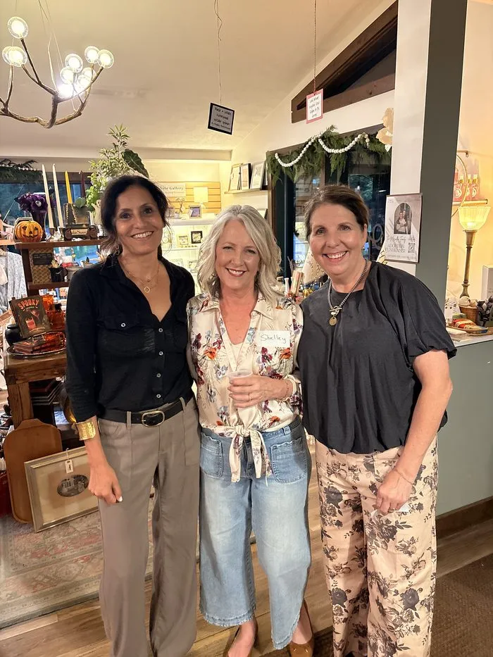 Three ICONS members posing together at the event